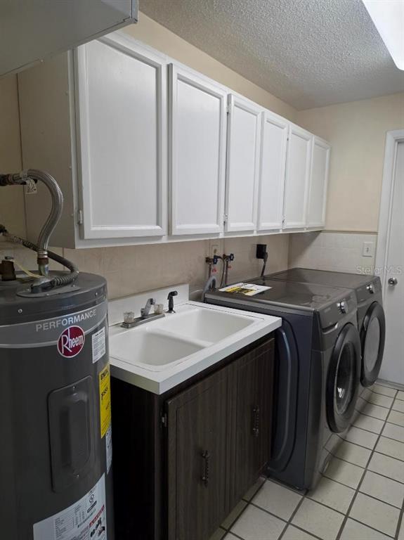 2111 North Keene Road Clearwater, FL 33763 - Photo 34 of 35 a utility room with a sink a washer and dryer