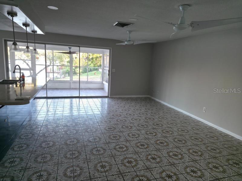 2111 North Keene Road Clearwater, FL 33763 - Photo 6 of 35 wooden floor in an empty room with a window