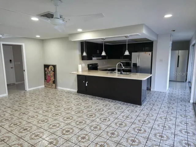 a kitchen with stainless steel appliances granite countertop a sink stove and cabinets