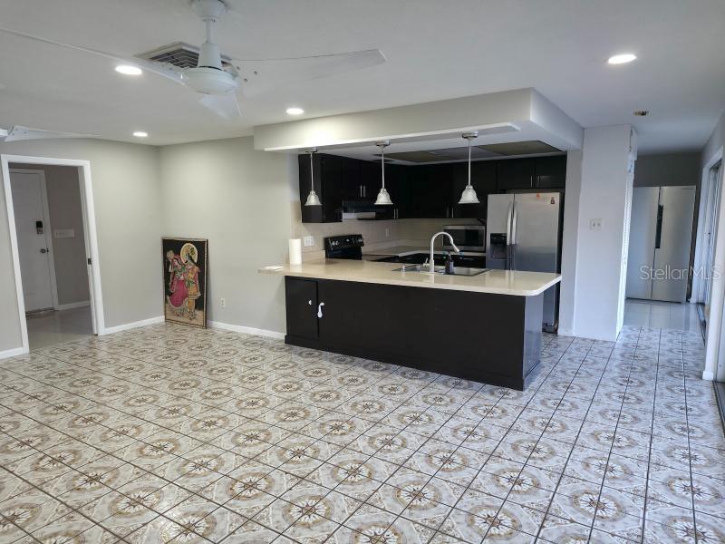 2111 North Keene Road Clearwater, FL 33763 - Photo 8 of 35 a kitchen with stainless steel appliances granite countertop a sink stove and cabinets