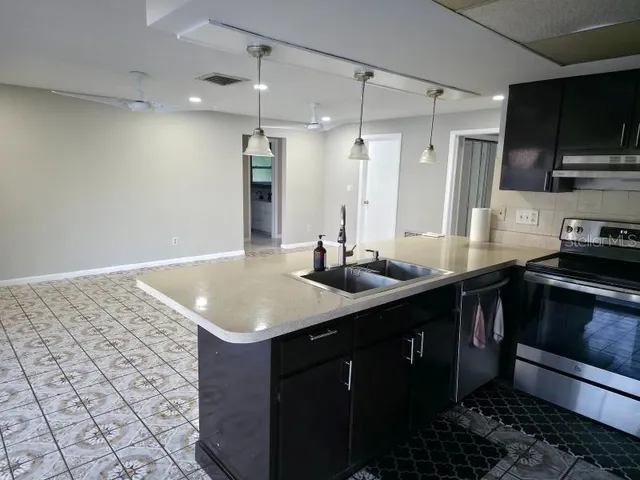 a kitchen with a sink cabinets and stainless steel appliances