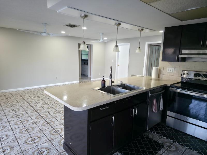 2111 North Keene Road Clearwater, FL 33763 - Photo 9 of 35 a kitchen with a sink cabinets and stainless steel appliances