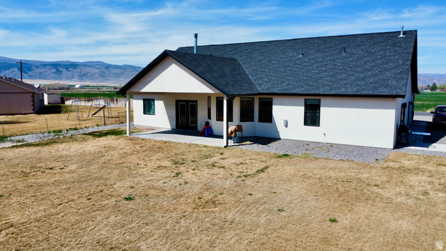 277 West 800 South Monroe, UT 84754 - Photo 39 of 46 Back of property with a mountain view, roof with shingles, and stucco siding