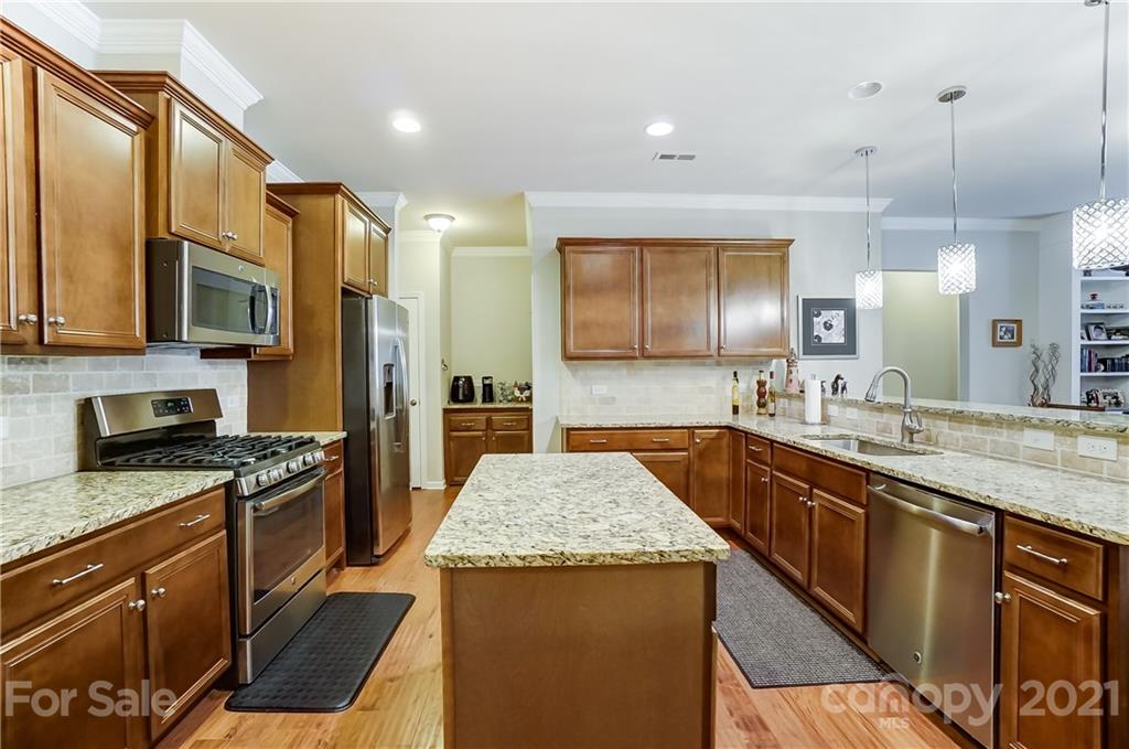 1765 Still River Way Fort Mill, SC 29708 - Photo 11 of 46 a kitchen with stainless steel appliances granite countertop a sink stove and refrigerator