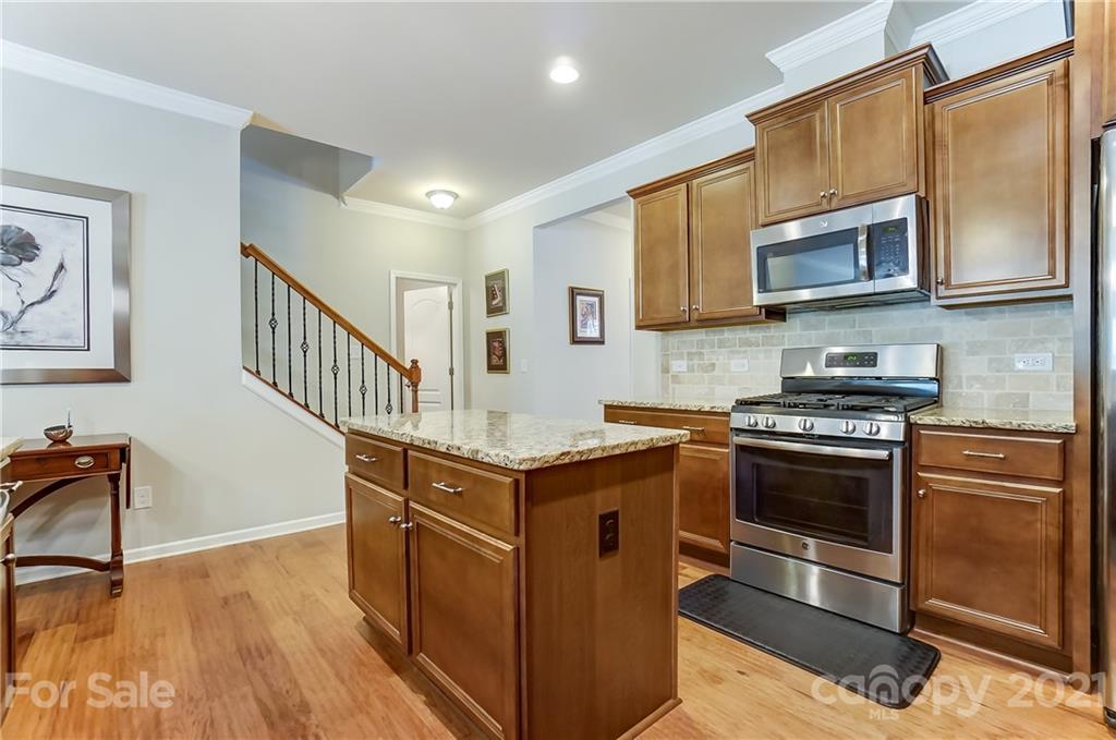1765 Still River Way Fort Mill, SC 29708 - Photo 14 of 46 a kitchen with stainless steel appliances granite countertop a stove a sink and a microwave