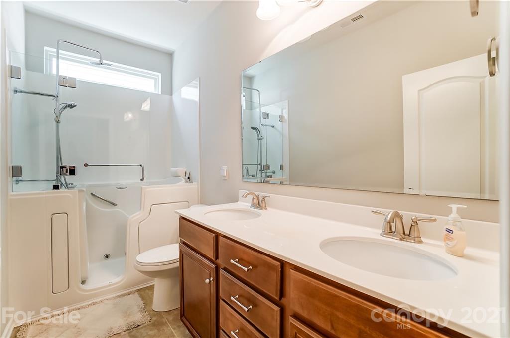 1765 Still River Way Fort Mill, SC 29708 - Photo 30 of 46 a bathroom with a granite countertop sink mirror and toilet