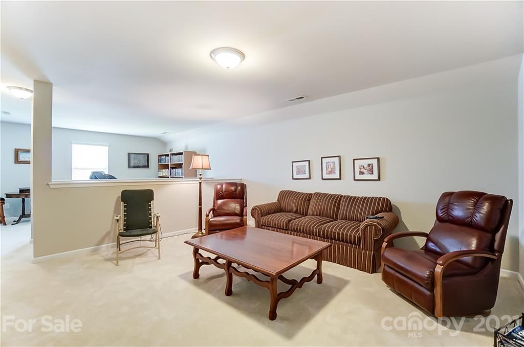 1765 Still River Way Fort Mill, SC 29708 - Photo 37 of 46 a living room with furniture and a dining table with kitchen view