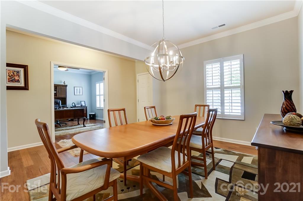 1765 Still River Way Fort Mill, SC 29708 - Photo 6 of 46 a view of a dining room with furniture a chandelier and wooden floor