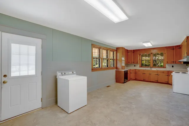 a view of a dining room with furniture and window