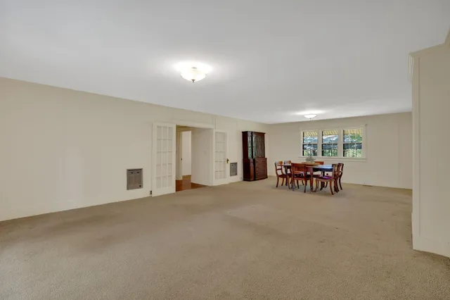 a view of a room with furniture and wooden floor