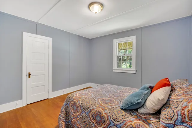a view of empty room with wooden floor and cabinet