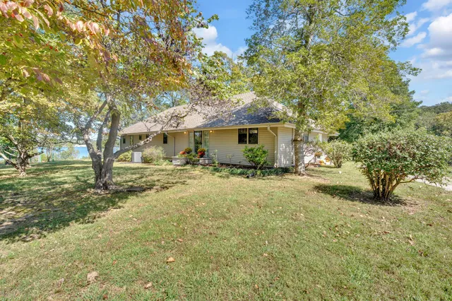 a view of a house with a backyard
