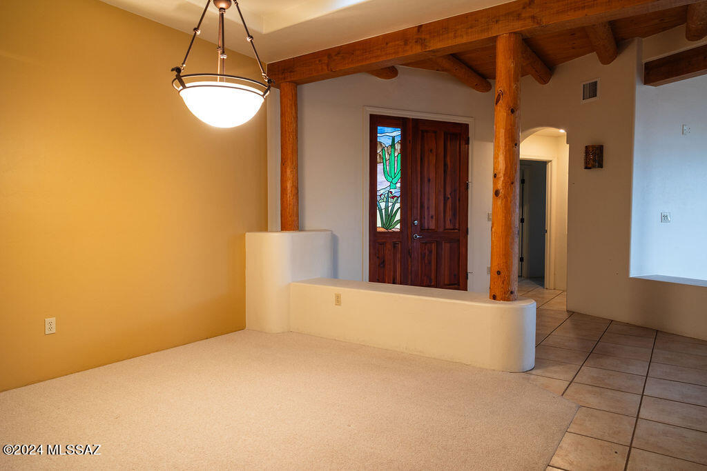 771 West Sedona Ridge Place Oro Valley, AZ 85755 - Photo 4 of 22 a view of empty room with wooden floor and chandelier