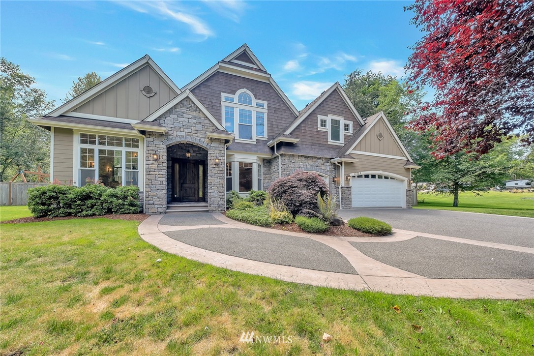 17725 Southeast 123rd Place Renton, WA 98059 - Photo 2 of 37 a front view of a house with a garden and plants