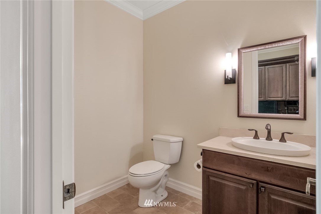 17725 Southeast 123rd Place Renton, WA 98059 - Photo 13 of 37 a bathroom with a toilet a sink and mirror