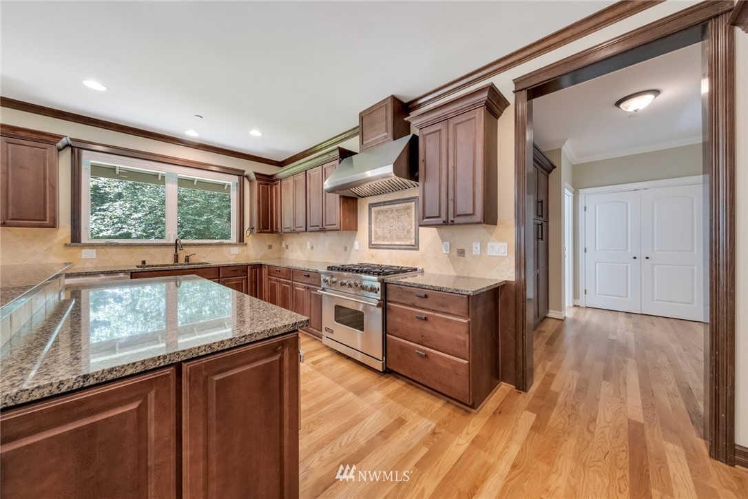 17725 Southeast 123rd Place Renton, WA 98059 - Photo 16 of 37 a kitchen with stainless steel appliances granite countertop a sink stove and cabinets
