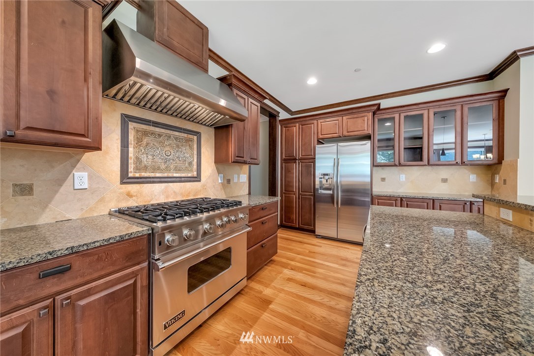17725 Southeast 123rd Place Renton, WA 98059 - Photo 17 of 37 a kitchen with stainless steel appliances granite countertop a stove a sink and a refrigerator
