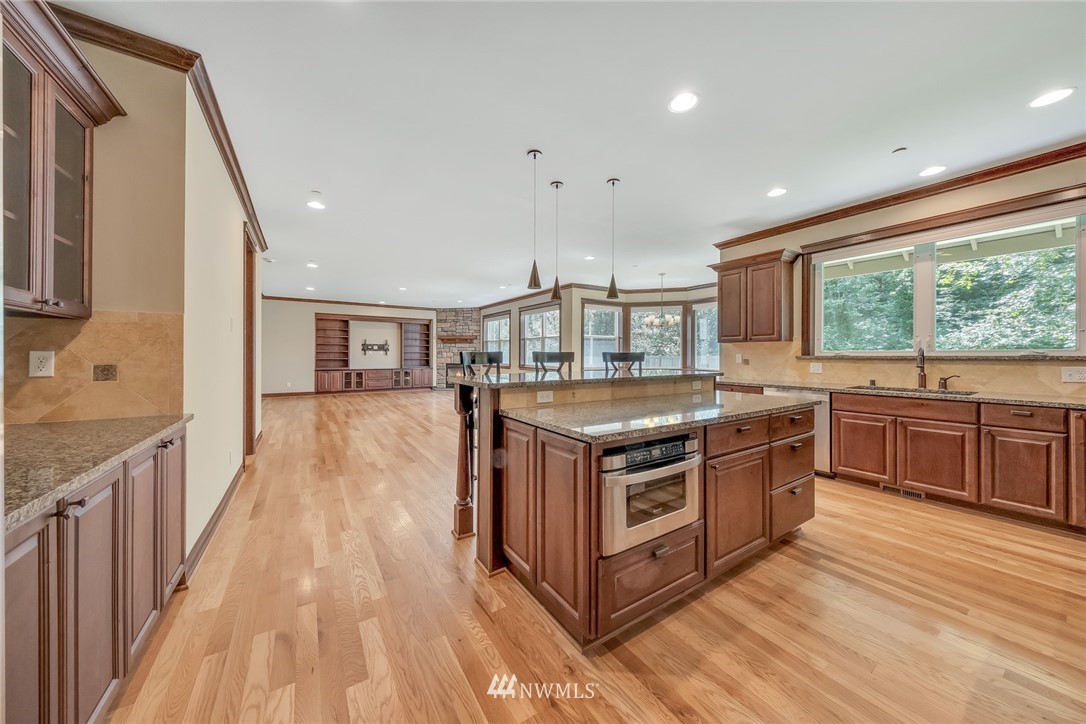 17725 Southeast 123rd Place Renton, WA 98059 - Photo 18 of 37 a kitchen with stainless steel appliances granite countertop a stove and a sink