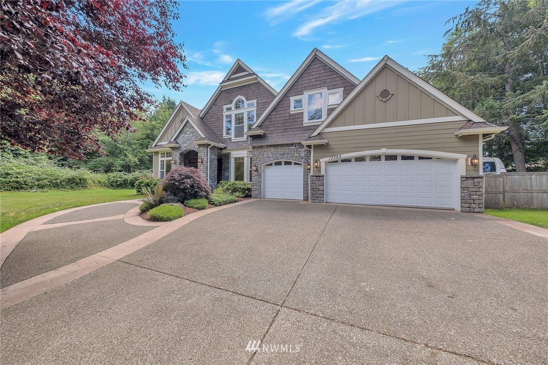 17725 Southeast 123rd Place Renton, WA 98059 - Photo 3 of 37 a front view of a house with a yard and garage