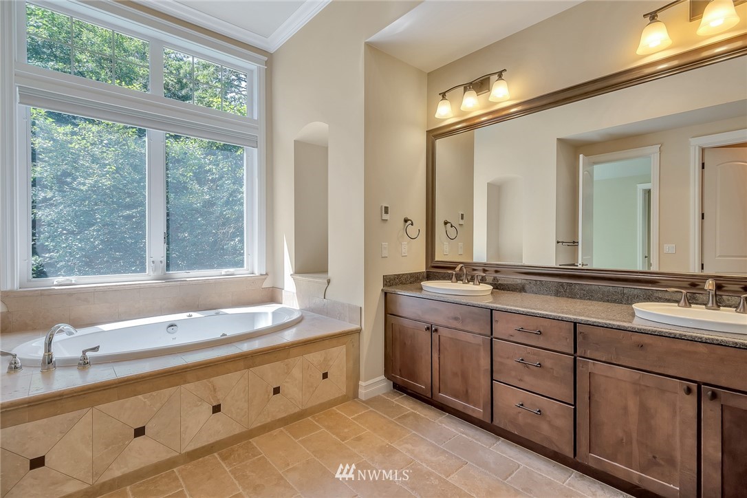 17725 Southeast 123rd Place Renton, WA 98059 - Photo 28 of 37 a bathroom with a double vanity sink large mirror and a window