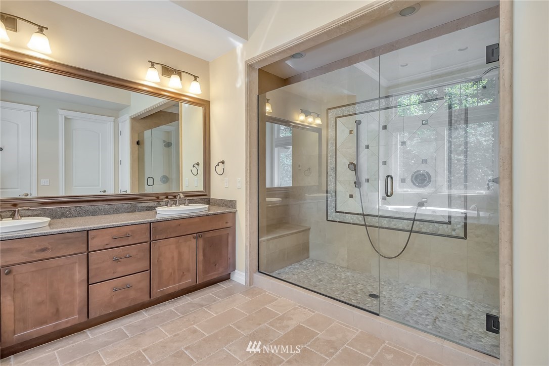 17725 Southeast 123rd Place Renton, WA 98059 - Photo 29 of 37 a bathroom with a shower a mirror and a sink