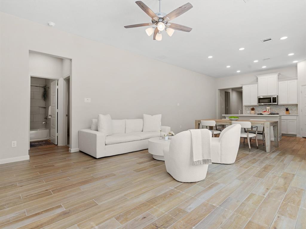 166 Palo Duro Bend Rhome, TX 76078 - Photo 7 of 40 Spacious living room with abundant natural light and open-concept layout.