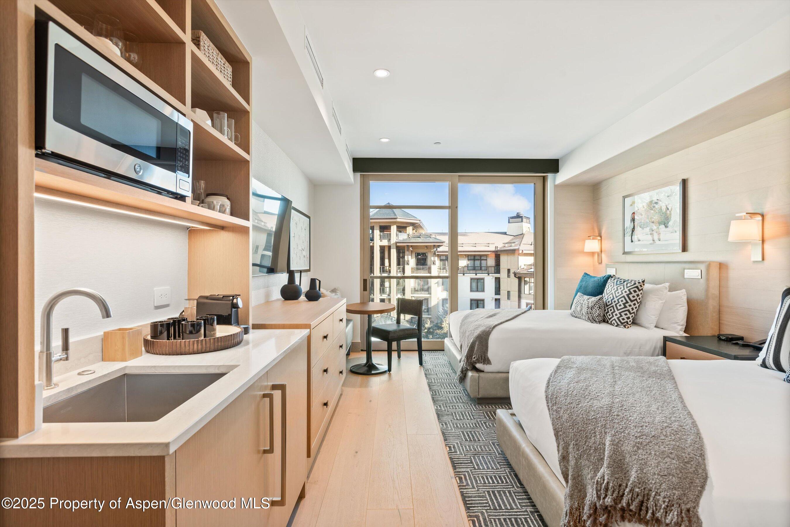 130 Wood Road, Unit 560562 Snowmass Village, CO 81615 - Photo 19 of 37 a bedroom with a bed and a large window