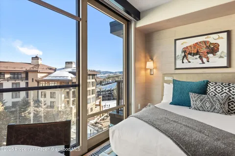 a bedroom with a bed and glass window