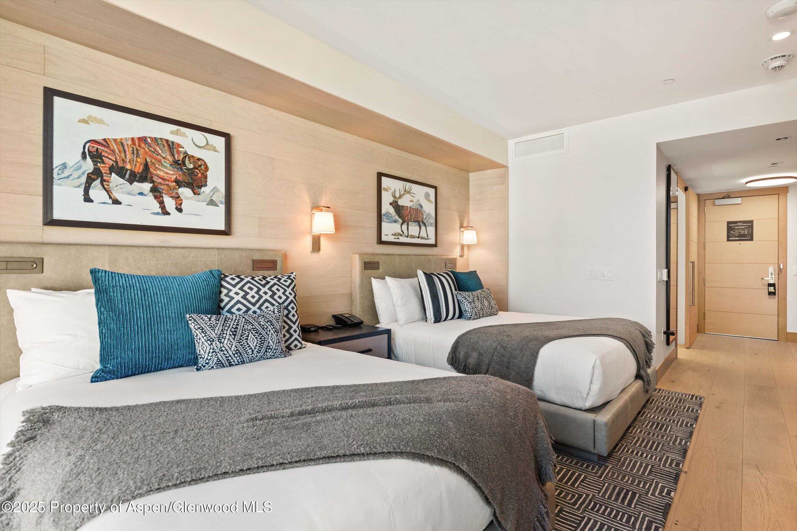 130 Wood Road, Unit 560562 Snowmass Village, CO 81615 - Photo 22 of 37 a bedroom with furniture and a painting