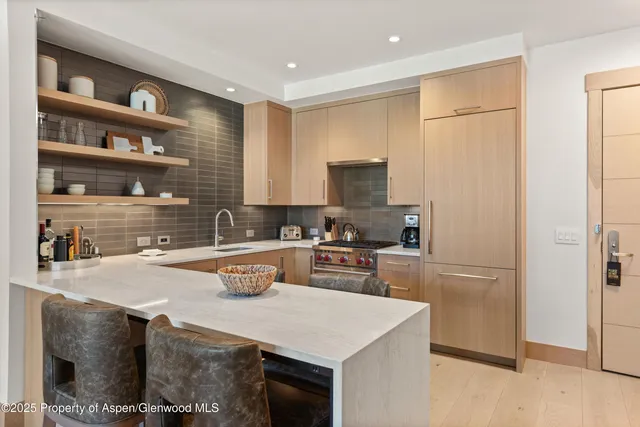 a kitchen with a sink a stove a refrigerator and cabinets