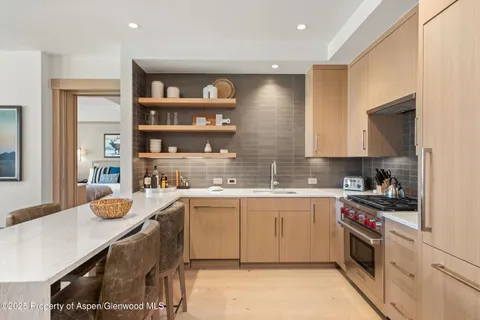 a kitchen with a sink a stove and cabinets