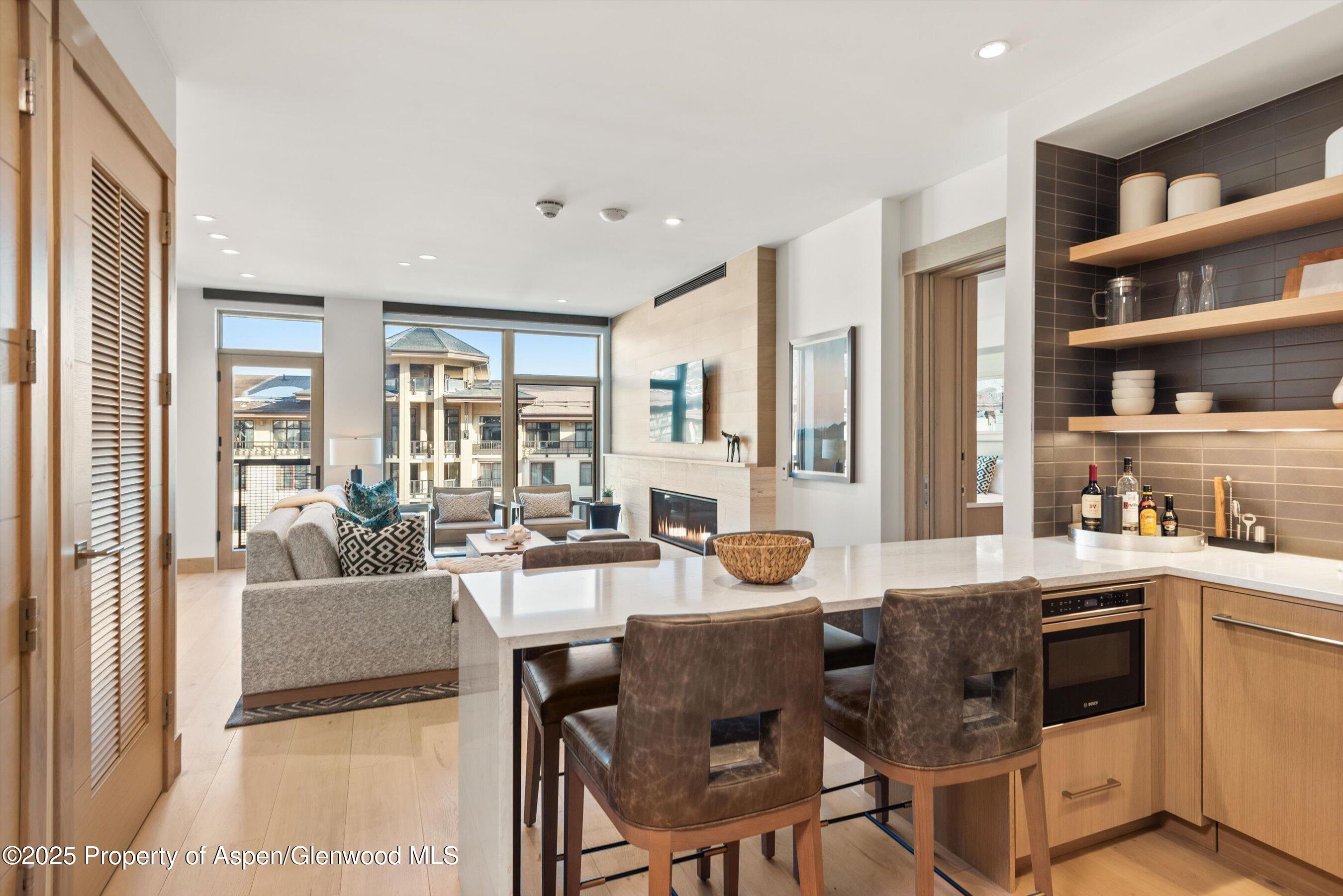 130 Wood Road, Unit 560562 Snowmass Village, CO 81615 - Photo 10 of 37 a dining hall with stainless steel appliances granite countertop a table and chairs