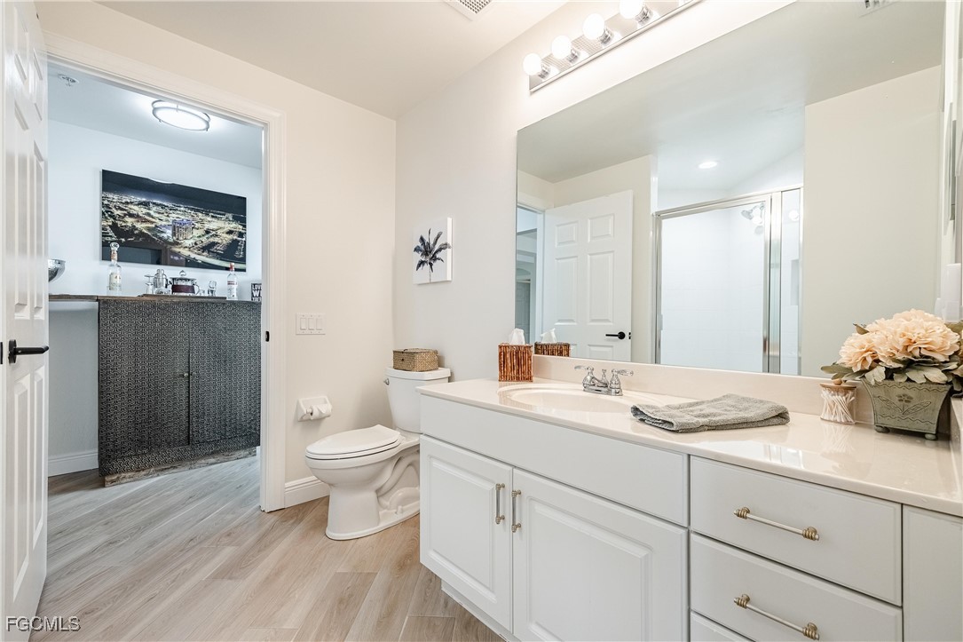 2745 First Street, Unit 705 Fort Myers, FL 33916 - Photo 11 of 49 a bathroom with a granite countertop toilet sink and mirror
