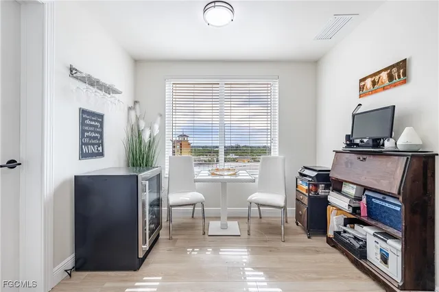 a view of a workspace with furniture and a window