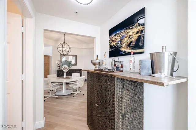 a living room with furniture a flat screen tv and kitchen view