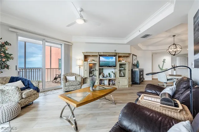 a living room with furniture and a floor to ceiling window
