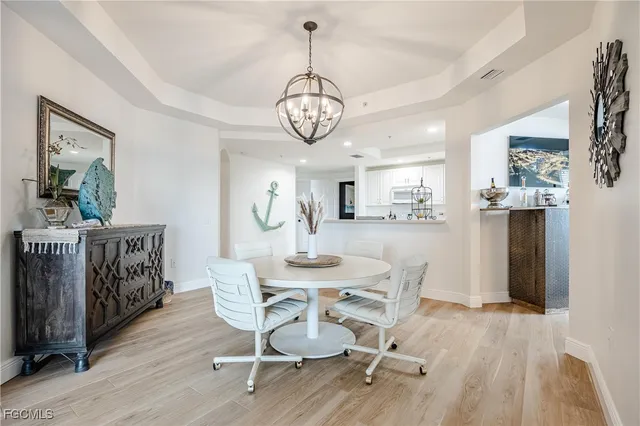 a view of a dining room with furniture wooden floor and a chandelier