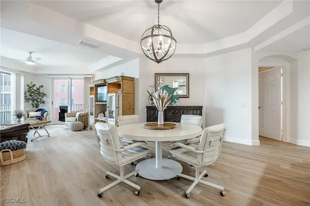 a view of a dining room with furniture wooden floor and chandelier