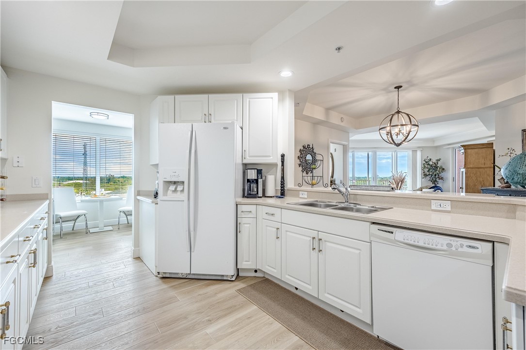 2745 First Street, Unit 705 Fort Myers, FL 33916 - Photo 22 of 49 a kitchen with white cabinets and stainless steel appliances