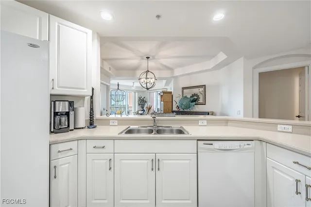 a kitchen with cabinets and chandelier