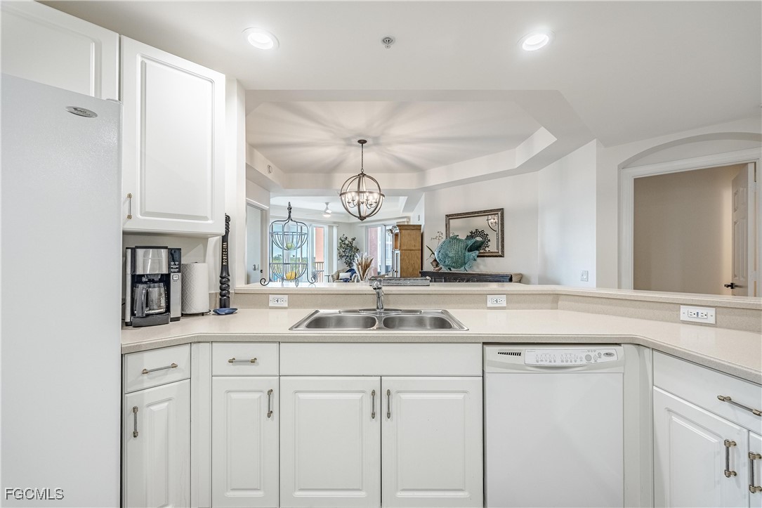 2745 First Street, Unit 705 Fort Myers, FL 33916 - Photo 23 of 49 a kitchen with cabinets and chandelier