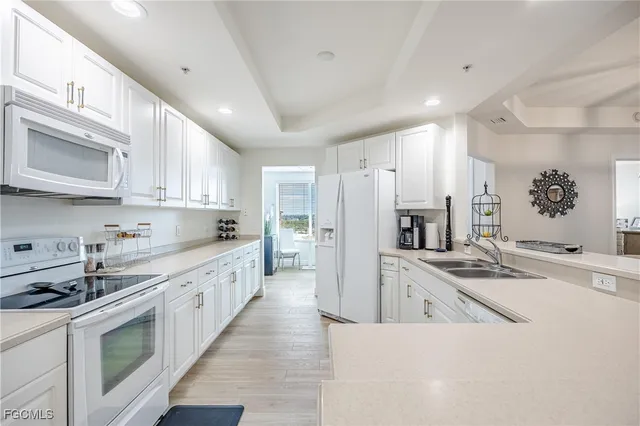 a large kitchen with stainless steel appliances granite countertop a lot of counter space and a refrigerator