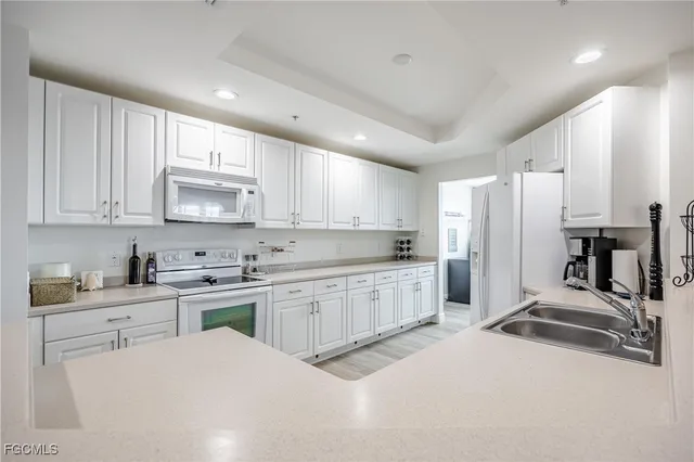 a large kitchen with kitchen island a sink stainless steel appliances and cabinets
