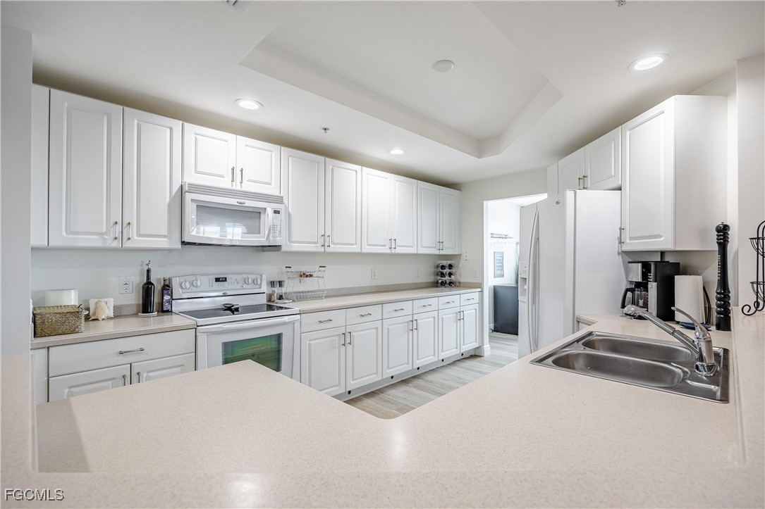 2745 First Street, Unit 705 Fort Myers, FL 33916 - Photo 25 of 49 a large kitchen with kitchen island a sink stainless steel appliances and cabinets