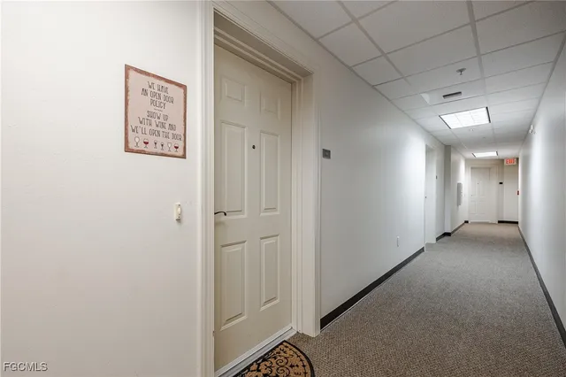 a room with pool table and windows