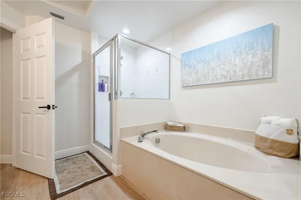 a bathroom with a bathtub and a shower