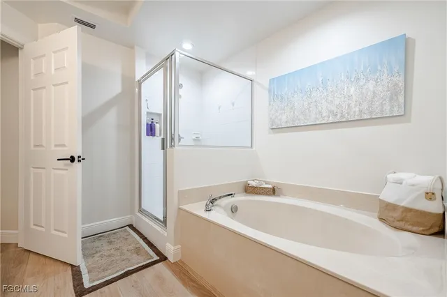 a bathroom with a bathtub and a shower