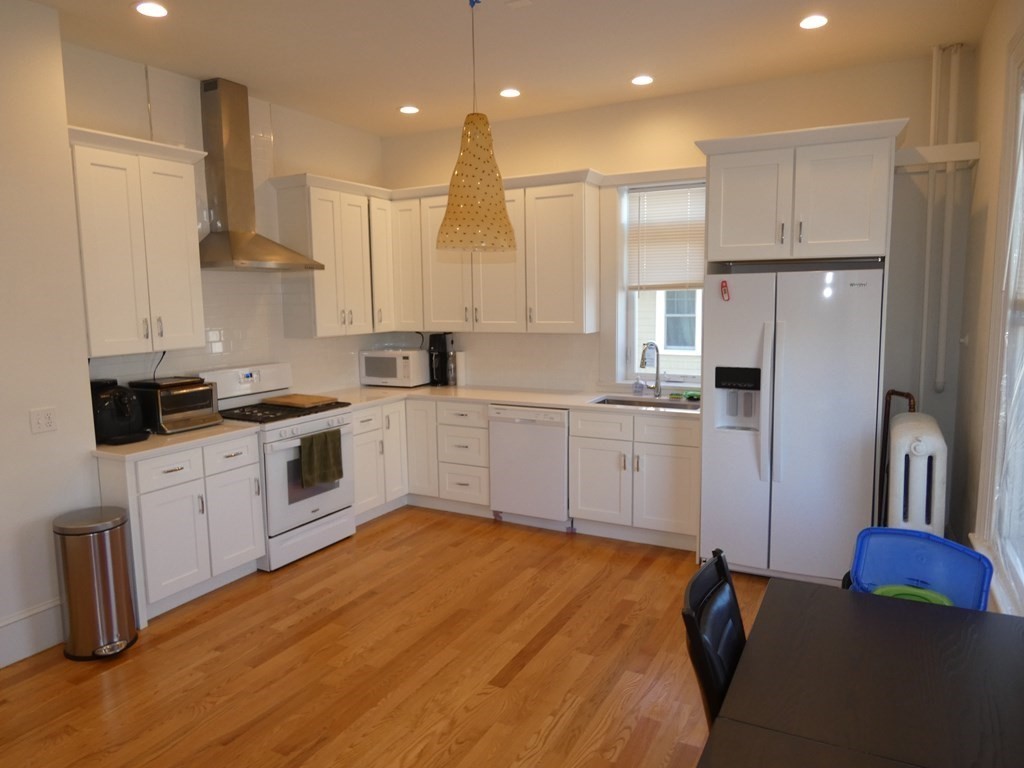 25 Davis Avenue, Unit 2 Brookline, MA 02445 - Photo 1 of 1 a kitchen with stainless steel appliances granite countertop a refrigerator sink and white cabinets