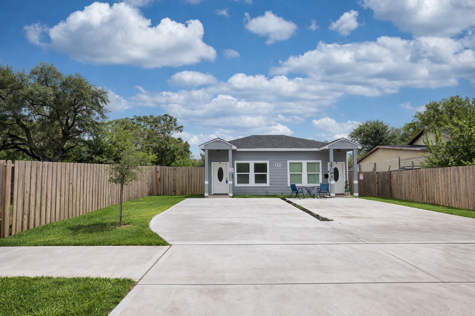 a front view of a house with a garden and pathway
