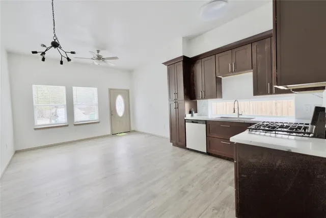 a kitchen with a stove a sink and a microwave